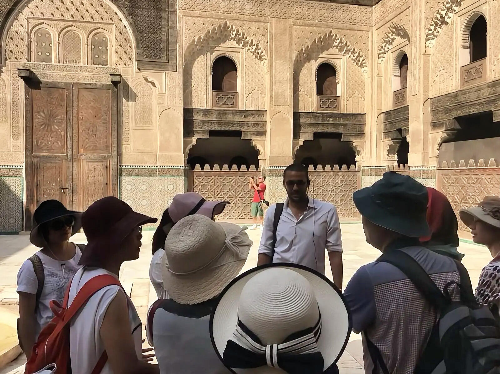 Reda Akrime talking to 7 Chinese tourists at a monument in Morocco